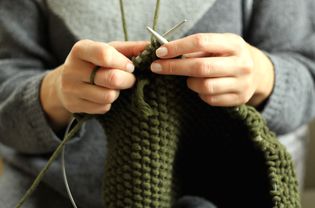 Woman knitting with two circular needles