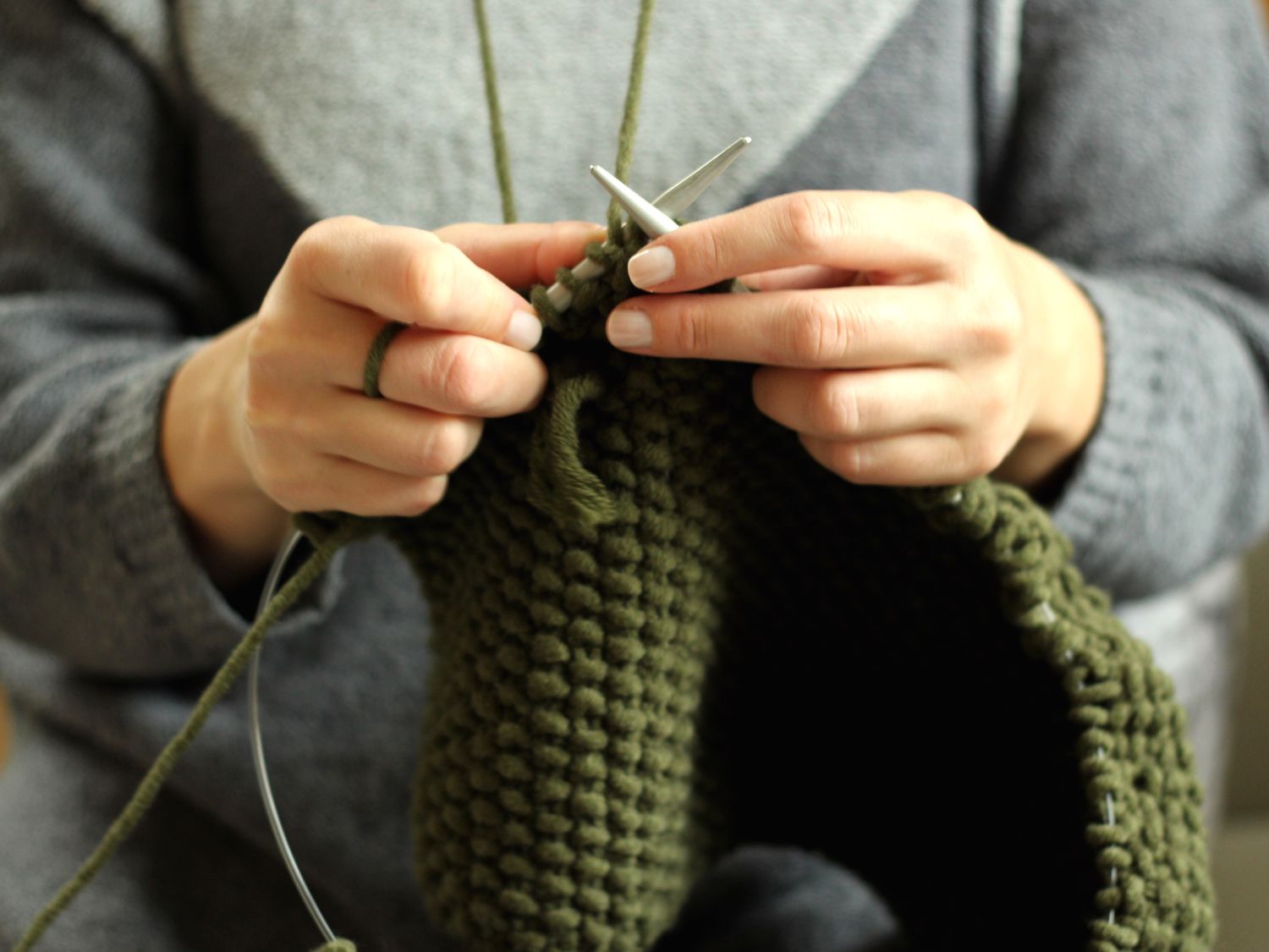Woman knitting with two circular needles