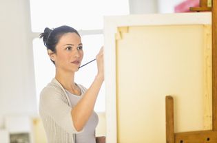 Woman painting on easel