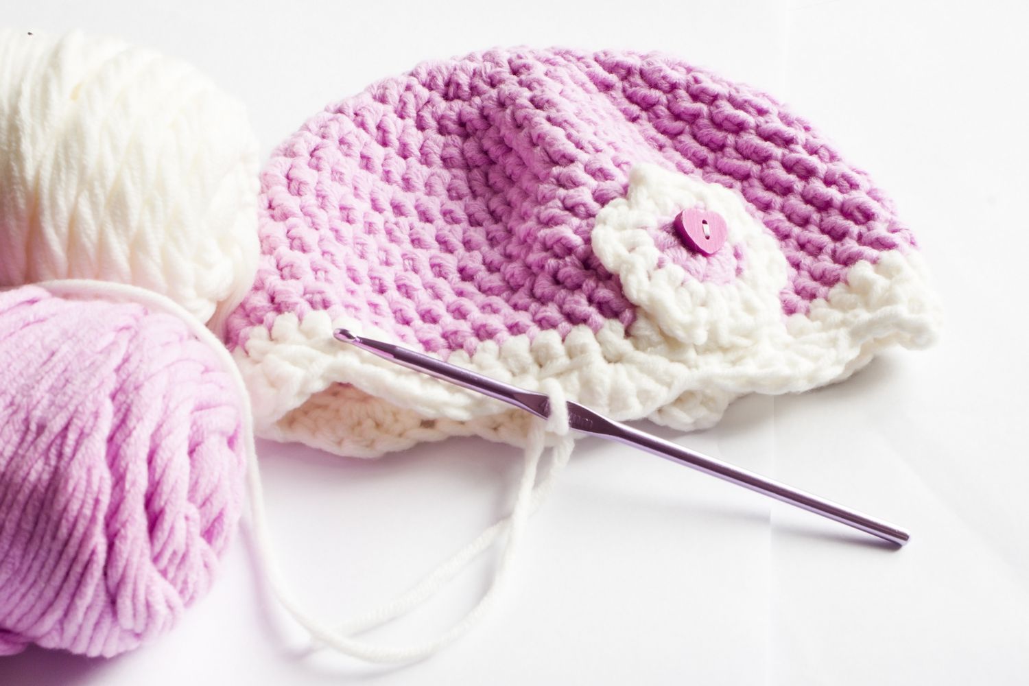 Yarn and pink baby hat