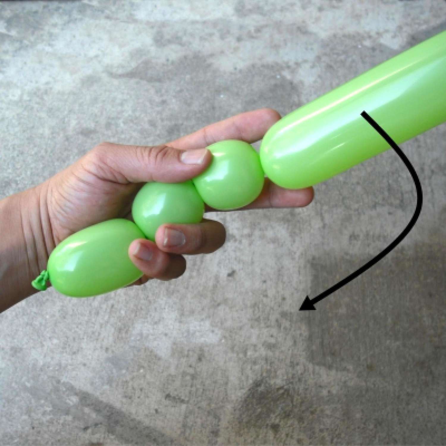 Person demonstrating how to twist a balloon.