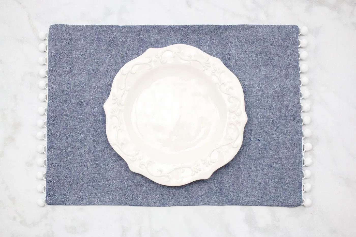 A blue place mat with white trim