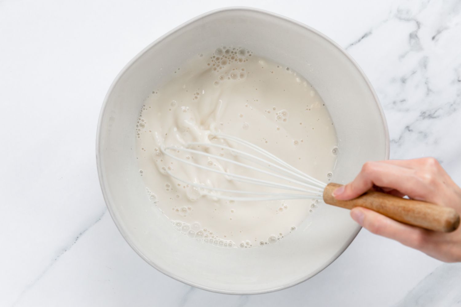Flour and water mixture mixed in bowl with whisk