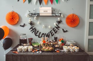 A Halloween themed party with food table and decorations