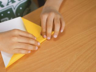 A child folding origami