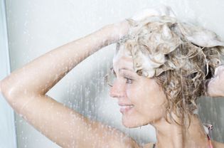 Woman shampoos head