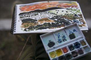 Landscape watercolor painting in sketchbook