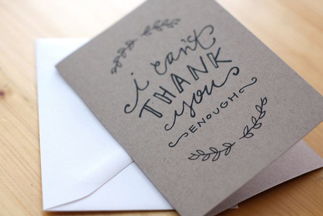 A card that says "I Can't Thank You Enough" laying on a table