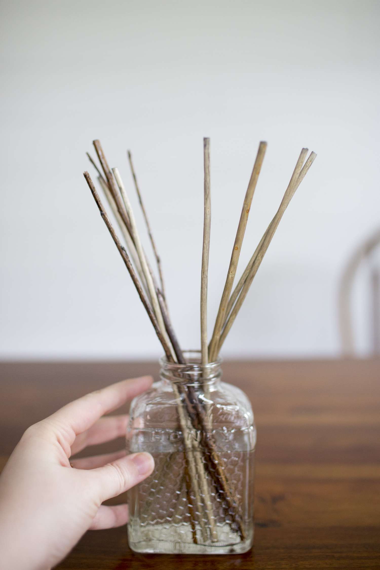 Adding twigs to the diffuser bottle.