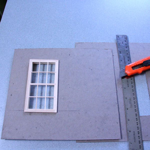 Davey Board pieces for a roombox are cut to accept a dolls house window.