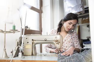Seamstress with sewing machine