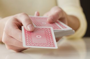 person holding deck of cards