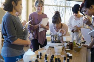 Women with notebooks learning about essential oils