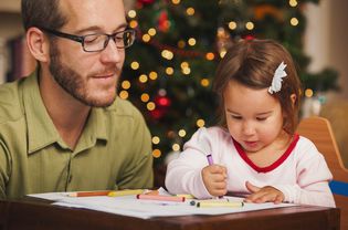 A young child coloring Santa coloring pages