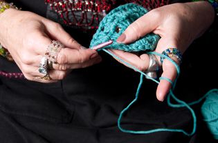 Woman crocheting the afghan stitch