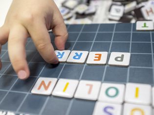 Child practices with word formation board game
