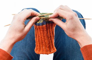 Woman knitting fair-isle sock