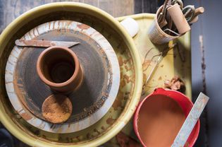 Cup and tools on pottery wheel