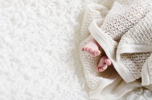 新生儿裹在针织毯子里