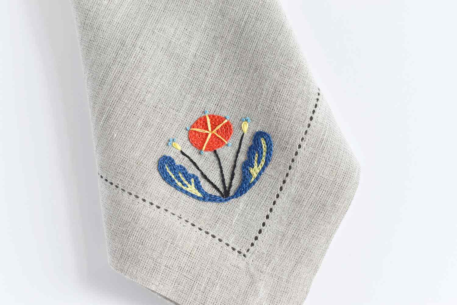 Scandinavian flower embroidered onto a napkin