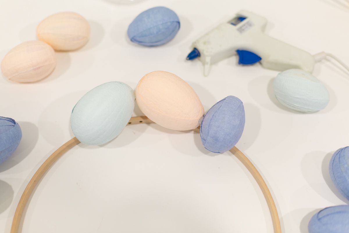 Glueing Easter eggs to embroidery hoop for Easter wreath