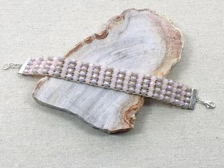 镶有珠子的手镯放在一块木头上