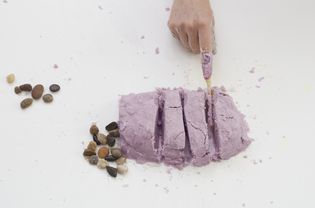 Person cutting through DIY kinetic sand