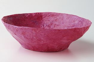 A pink papier-mache bowl