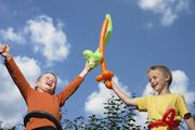 Kids playing with balloon swords