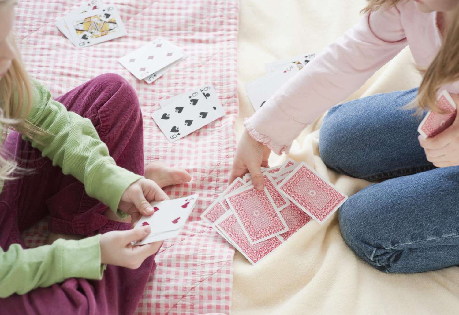 Two young girls playing card game, close up