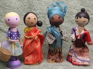 Clothespeg dolls in saree, kimono, gele, bubo and iro, and contemporary dress.