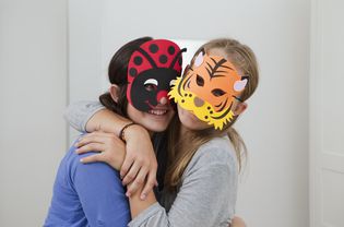 Smiling kids wearing colorful masks