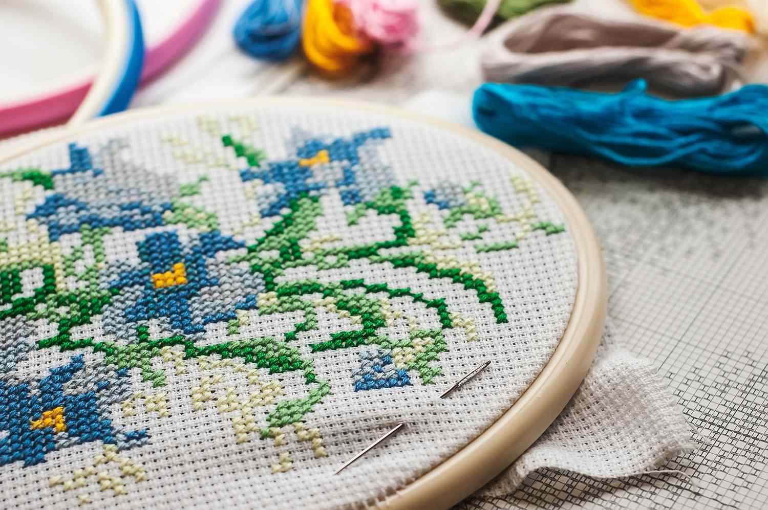 A close-up of a floral cross stitch project