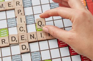 person playing a q in scrabble
