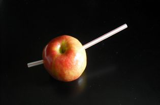 Apple with a straw