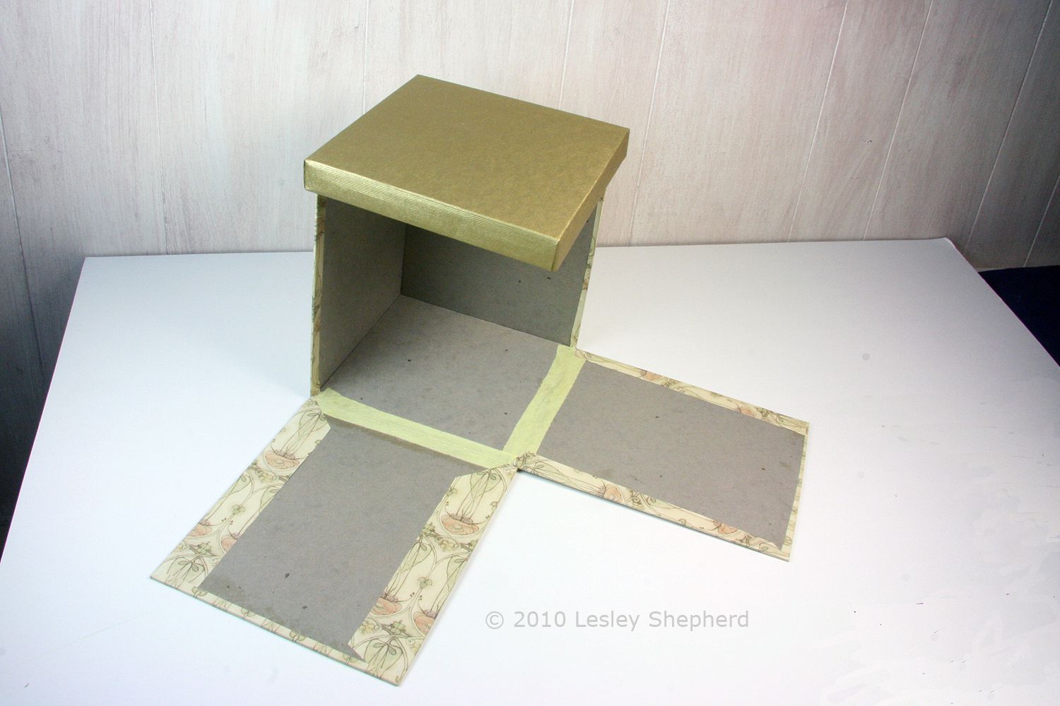 Open breakaway box for a scale display showing two hinged drop down sides.