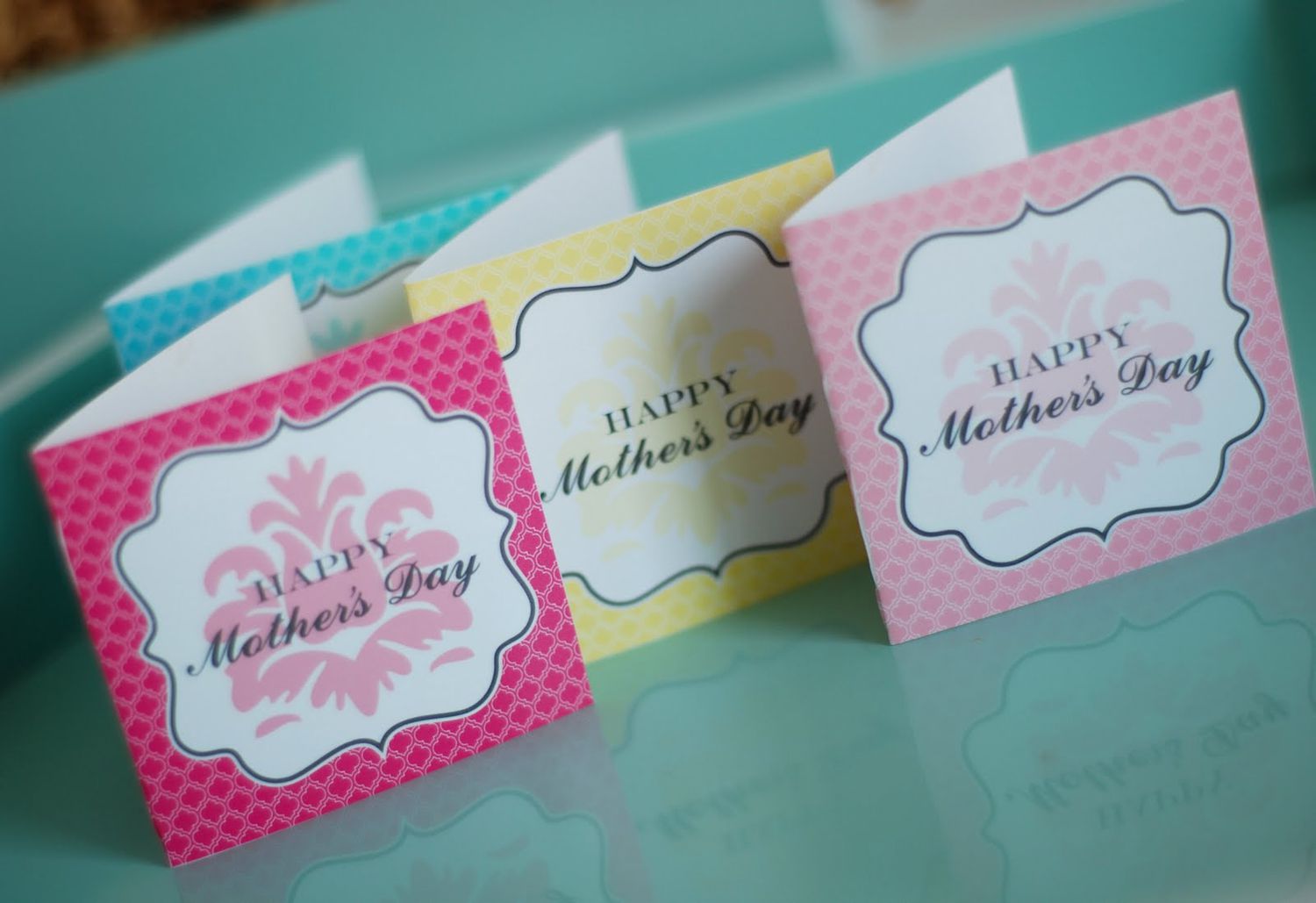 Colorful miniature Mother's Day cards on a table