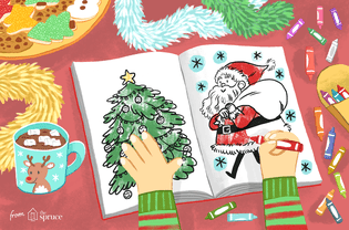 一个孩子正在用蜡笔、可可和节日饼干给桌子上的两张圣诞彩绘纸上色