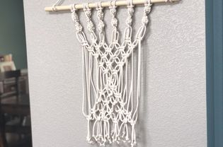 A macrame wall hanging in a home