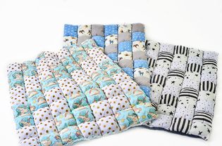 Bundle of colorful patchworked comforters with unicorn and stars design on white background - three pieces