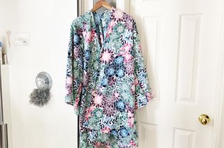 A colorful robe hanging in a bathroom
