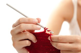 An up close picture of someone crocheting