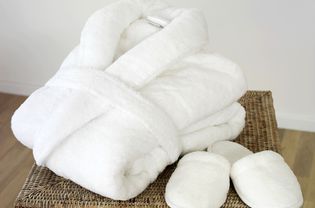A folded bath robe with slippers