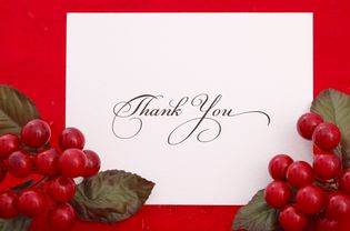 A Christmas thank you card with holly and berries