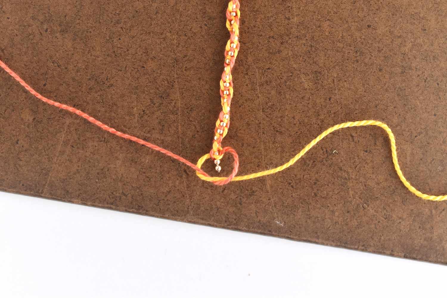 Tie a Square Knot at the End of the Bracelet