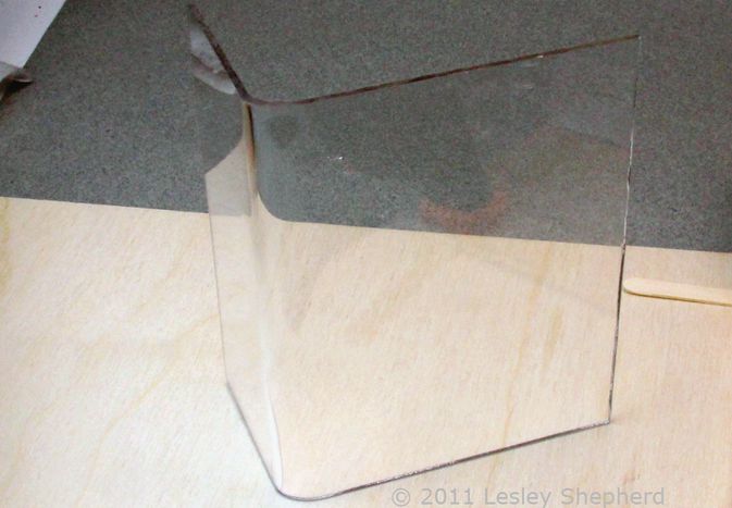 Neat, even gentle curve bend in sheet plastic made with a simple jig and an embossing heat tool.