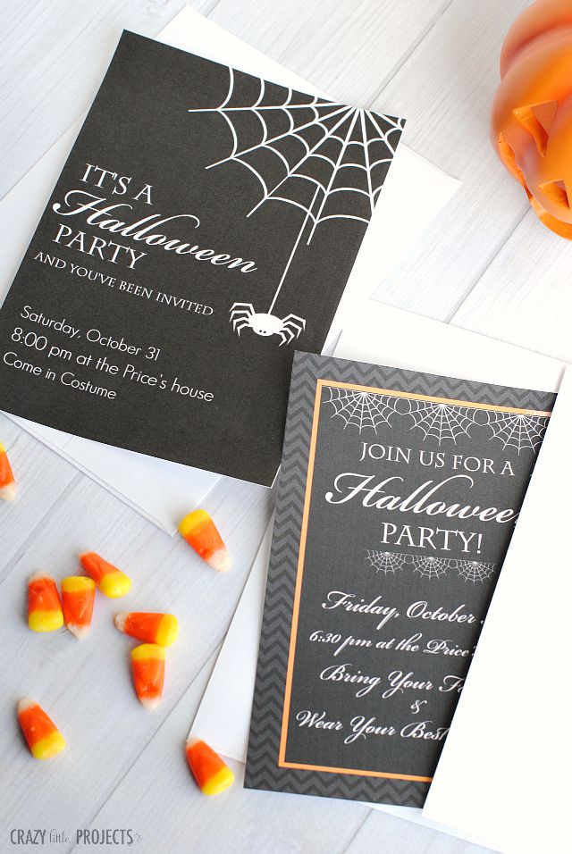 Black Halloween Invites on a Table With Candy Corn