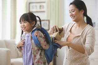 亚洲妈妈帮助女儿准备好去上学