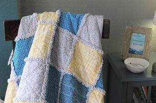 A rag quilt draped on a chair