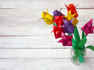 colorful origami tulip flowers bouquet in glass vase